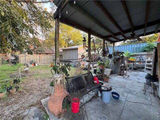 view of patio / terrace with ceiling fan and a shed