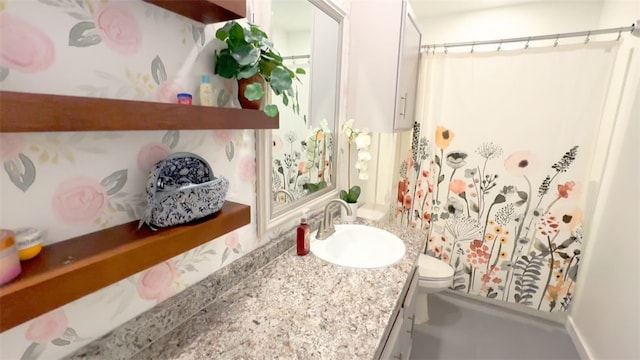 bathroom with vanity, toilet, and walk in shower