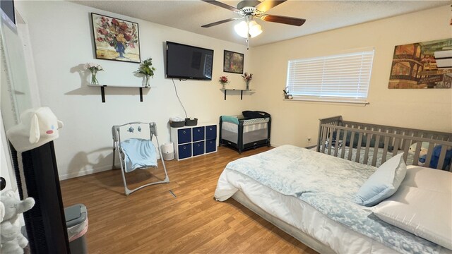 bedroom featuring ceiling fan and hardwood / wood-style floors