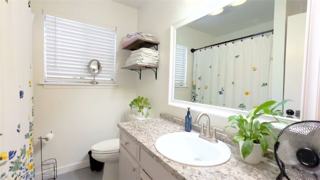 bathroom featuring vanity and toilet