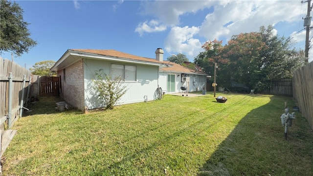 rear view of property featuring a lawn