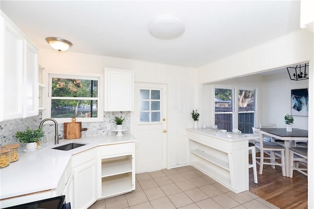 4429 Moravian Dr, Corpus Christi, TX 78411 - kitchen with open shelves, a sink, white cabinets, light countertops, and backsplash