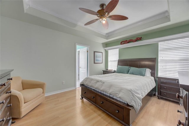 7313 Prairie Dr, Corpus Christi, TX 78413 - bedroom featuring a raised ceiling, light wood-style flooring, crown molding, a ceiling fan, and connected bathroom