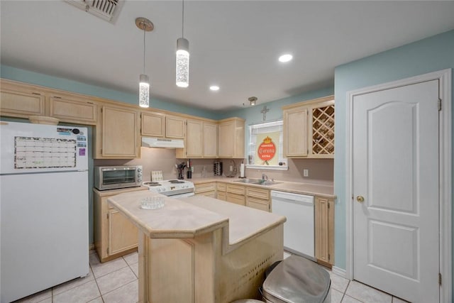 7313 Prairie Dr, Corpus Christi, TX 78413 - kitchen with white appliances, under cabinet range hood, light brown cabinetry, light countertops, and recessed lighting
