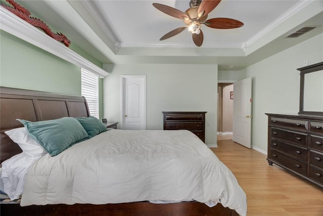 7313 Prairie Dr, Corpus Christi, TX 78413 - bedroom featuring a tray ceiling, crown molding, light wood-style floors, and ceiling fan