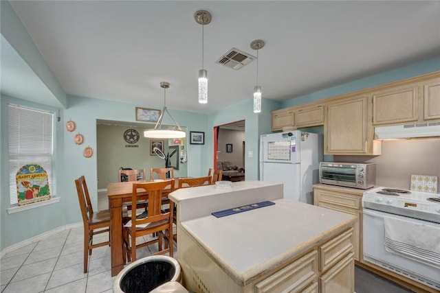 7313 Prairie Dr, Corpus Christi, TX 78413 - kitchen featuring white appliances, under cabinet range hood, light countertops, a kitchen island, and light brown cabinetry