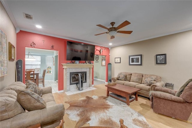 7313 Prairie Dr, Corpus Christi, TX 78413 - living area featuring ceiling fan, ornamental molding, recessed lighting, light wood-style flooring, and a tile fireplace
