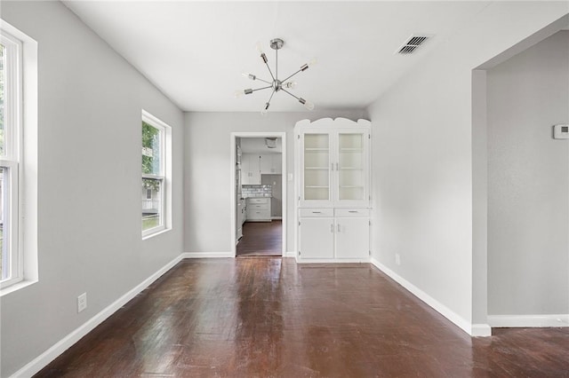 3740 Brooks Dr, Corpus Christi, TX 78408 - unfurnished dining area featuring a chandelier and dark wood-style flooring