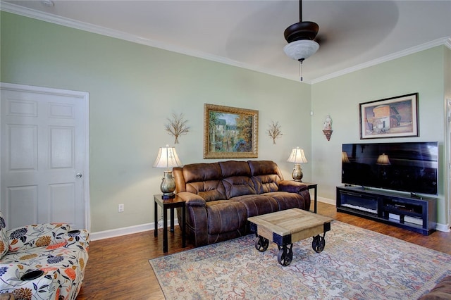 living room with dark hardwood / wood-style flooring, ceiling fan, and crown molding