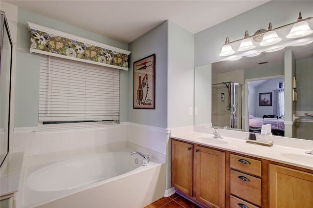 bathroom with vanity, tile patterned flooring, and separate shower and tub