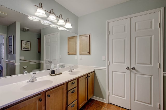 bathroom featuring vanity, tile patterned flooring, and toilet