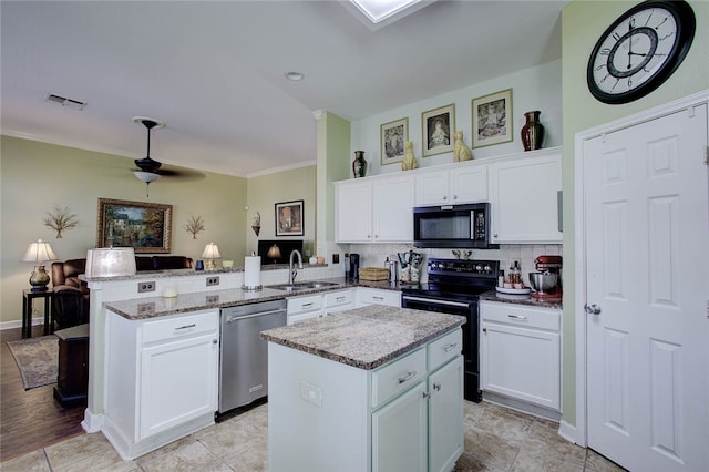 kitchen with black appliances, white cabinets, kitchen peninsula, and a center island