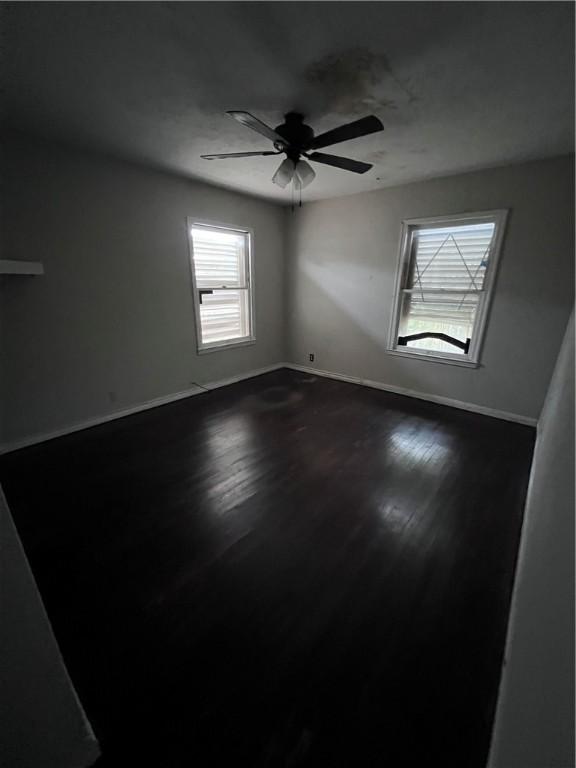 unfurnished room with hardwood / wood-style floors and ceiling fan