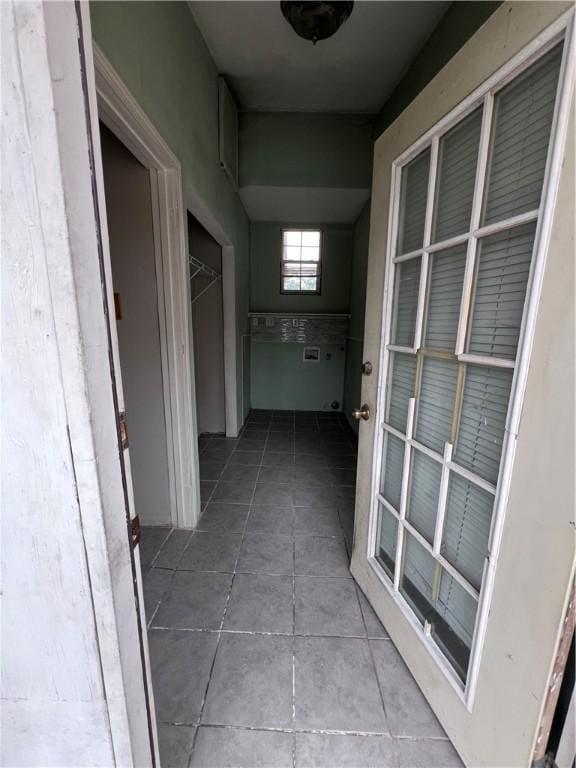 hall with light tile patterned floors