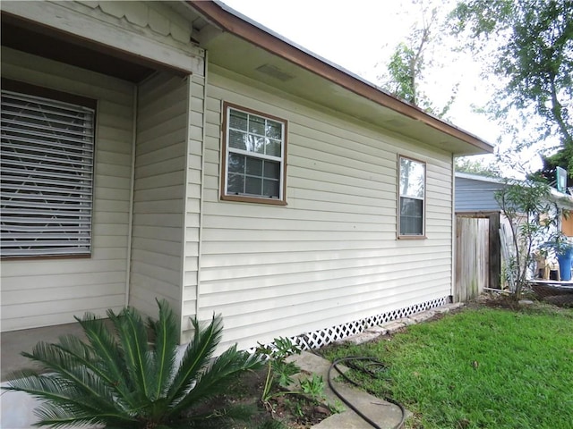 view of home's exterior with a lawn