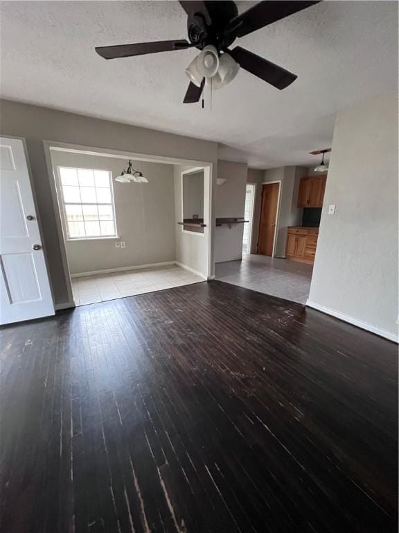 unfurnished living room with ceiling fan, wood-type flooring, and a textured ceiling