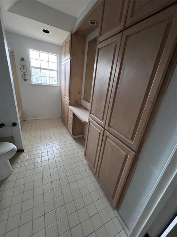 bathroom featuring tile patterned floors and toilet