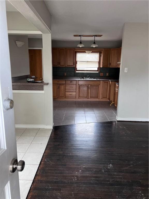 kitchen featuring tasteful backsplash, sink, and hardwood / wood-style floors