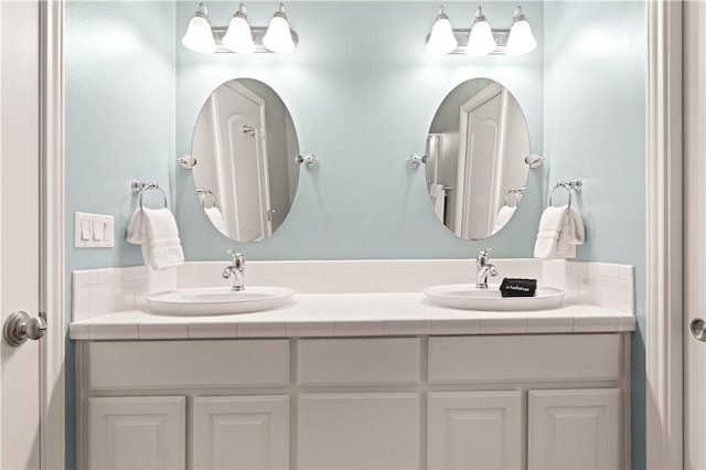 bathroom featuring a sink and double vanity