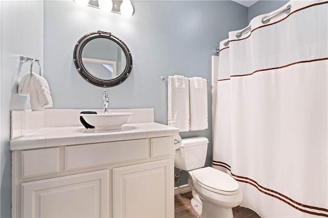 full bath with vanity, a shower with curtain, toilet, and wood finished floors