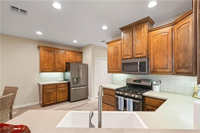 kitchen with visible vents, backsplash, recessed lighting, appliances with stainless steel finishes, and a sink