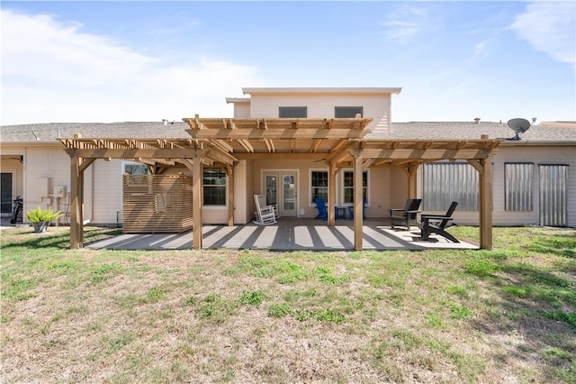 back of property with a patio, french doors, a pergola, and a lawn