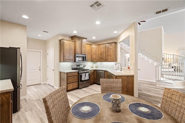 kitchen with visible vents, stainless steel appliances, and light countertops