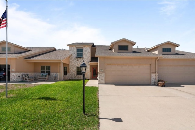 view of front facade featuring stone siding, a garage, driveway, and a front lawn