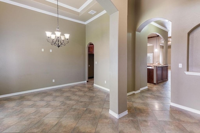 6901 Ridgeline Ct, Corpus Christi, TX 78413 - unfurnished room featuring arched walkways, tile patterned flooring, ornamental molding, baseboards, and a chandelier