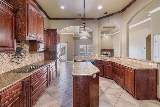 6901 Ridgeline Ct, Corpus Christi, TX 78413 - kitchen featuring ornamental molding, a kitchen island, a sink, tasteful backsplash, and stainless steel appliances
