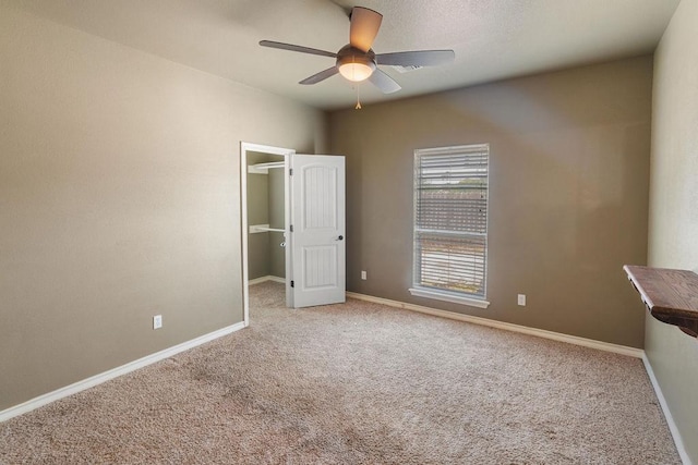 6901 Ridgeline Ct, Corpus Christi, TX 78413 - unfurnished bedroom featuring carpet, a walk in closet, baseboards, ceiling fan, and a closet