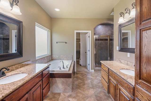 6901 Ridgeline Ct, Corpus Christi, TX 78413 - bathroom with a stall shower, two vanities, a bath, a walk in closet, and tile patterned flooring