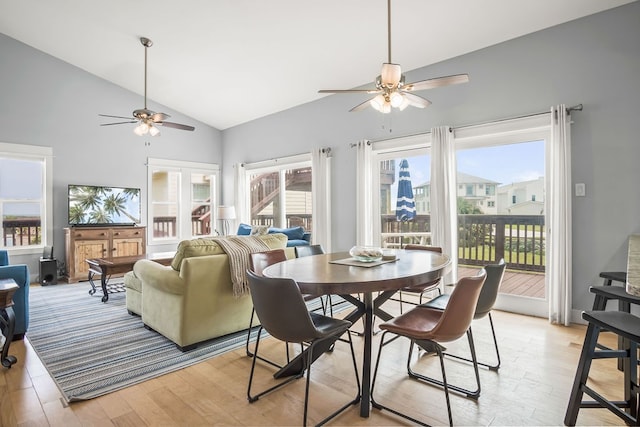 dining area with high vaulted ceiling, french doors, ceiling fan, and light hardwood / wood-style flooring