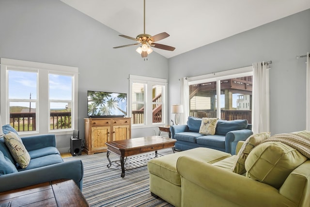 living room with ceiling fan and high vaulted ceiling