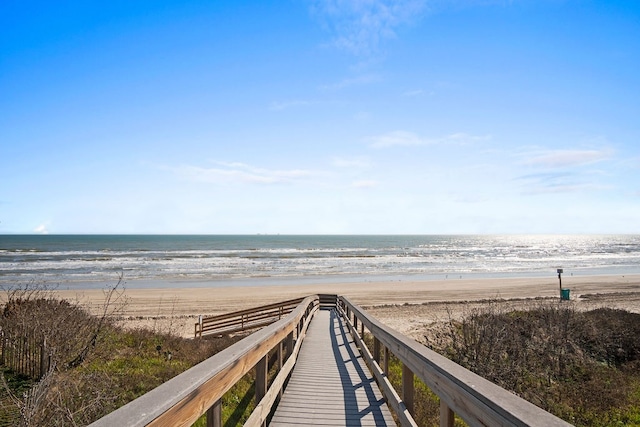 view of property's community with a beach view and a water view