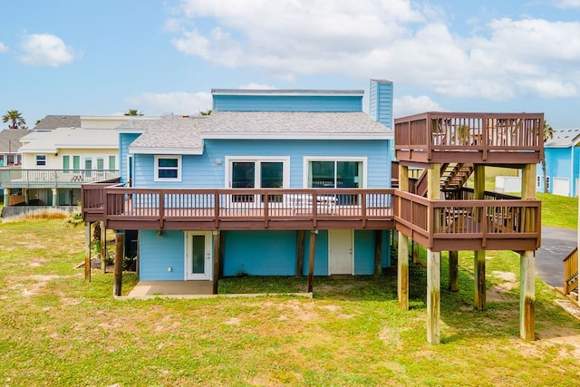 back of house featuring a deck and a yard