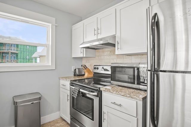 kitchen featuring backsplash, white cabinetry, appliances with stainless steel finishes, and light stone counters