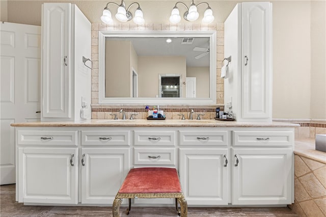 bathroom with wood-type flooring, vanity, and ceiling fan