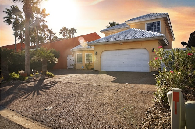 mediterranean / spanish home with a garage