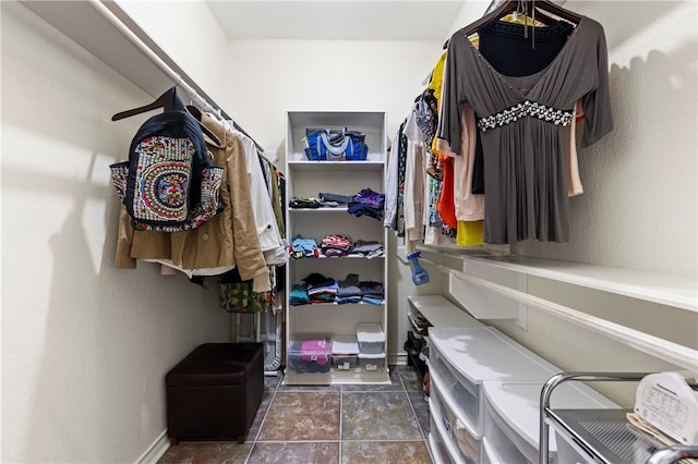 spacious closet featuring dark tile patterned flooring