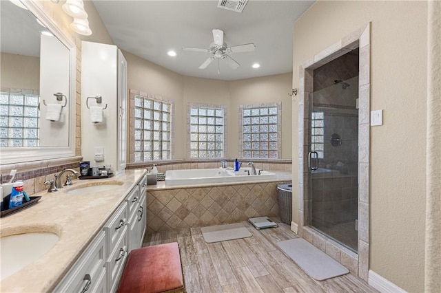 13953 Dasmarinas Dr, Corpus Christi, TX 78418 - bathroom featuring plenty of natural light, a bath, wood finished floors, double vanity, and recessed lighting