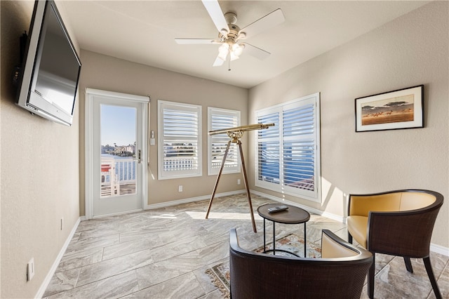 sitting room featuring ceiling fan