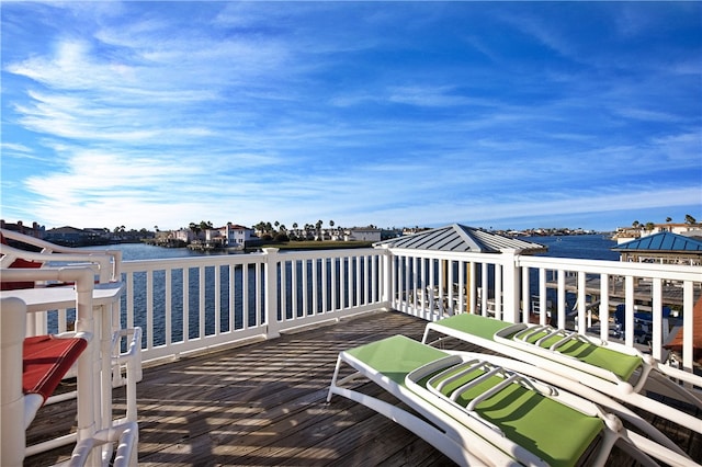 wooden deck featuring a water view