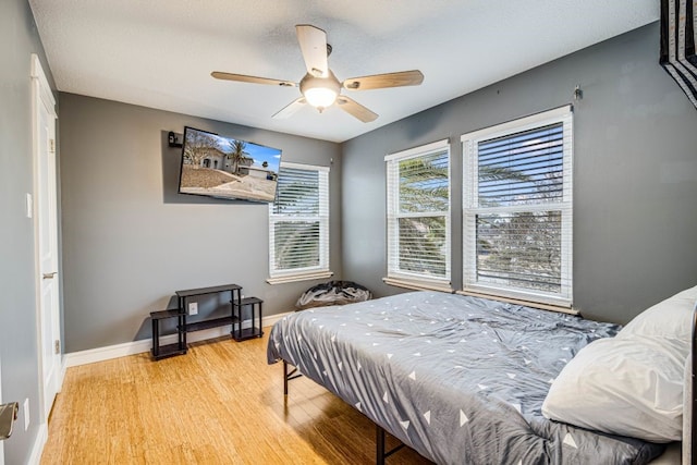 bedroom featuring ceiling fan and light hardwood / wood-style flooring