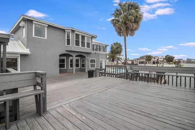 wooden deck with a pool