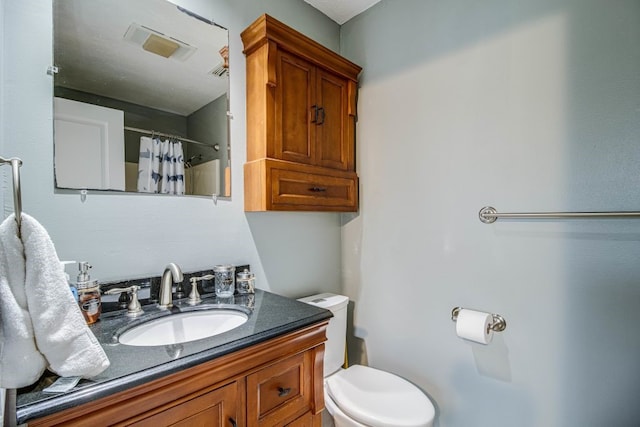 bathroom featuring vanity, curtained shower, and toilet