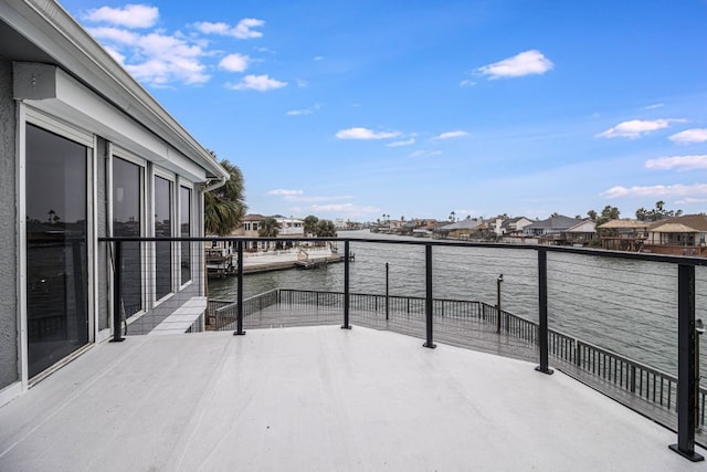 view of patio with a balcony and a water view