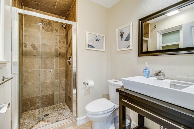 bathroom featuring walk in shower, vanity, toilet, and tile patterned flooring