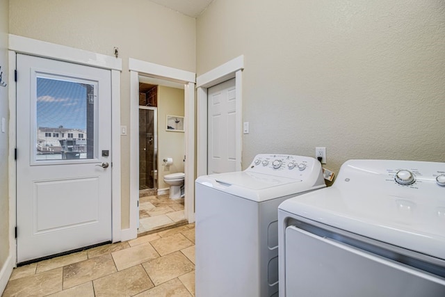 laundry area with washing machine and clothes dryer