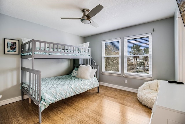 bedroom featuring hardwood / wood-style flooring and ceiling fan